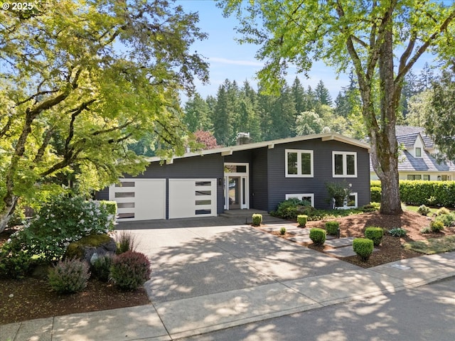 17739 Cardinal Dr, Lake Oswego, OR 97034 - view of front of property featuring concrete driveway, a garage, and a chimney