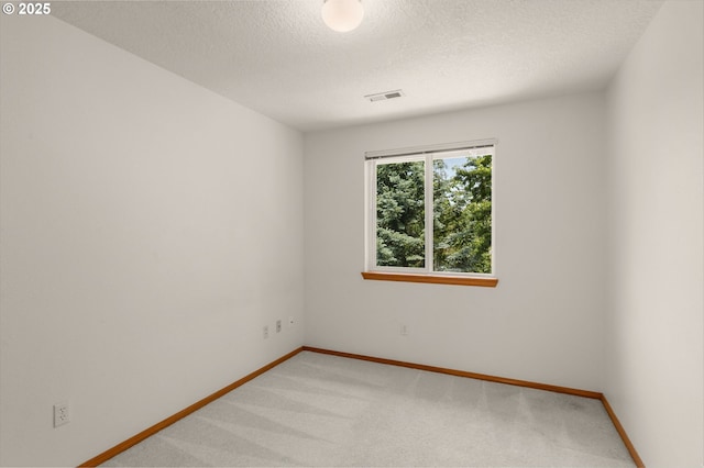 16149 SW Snapdragon Ln, Tigard, OR 97223 - spare room featuring light colored carpet and a textured ceiling