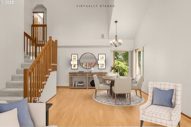 16149 SW Snapdragon Ln, Tigard, OR 97223 - dining space with a chandelier, wood finished floors, stairs, and high vaulted ceiling