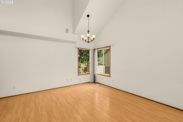 16149 SW Snapdragon Ln, Tigard, OR 97223 - empty room with a chandelier, light wood finished floors, and high vaulted ceiling