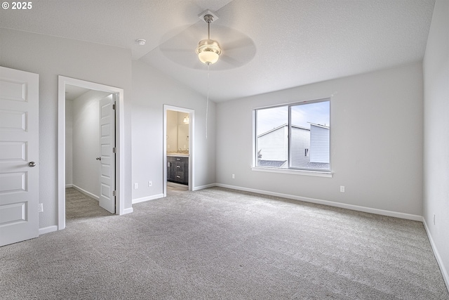 50 Shore Dr, Saint Helens, OR 97051 - unfurnished bedroom with carpet flooring, lofted ceiling, baseboards, a spacious closet, and connected bathroom