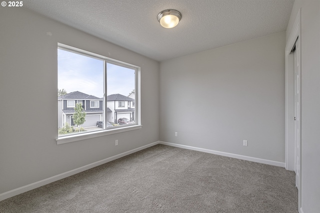 50 Shore Dr, Saint Helens, OR 97051 - carpeted empty room featuring healthy amount of natural light, a textured ceiling, and baseboards