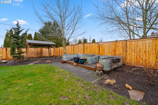 view of yard with a fenced backyard and a garden