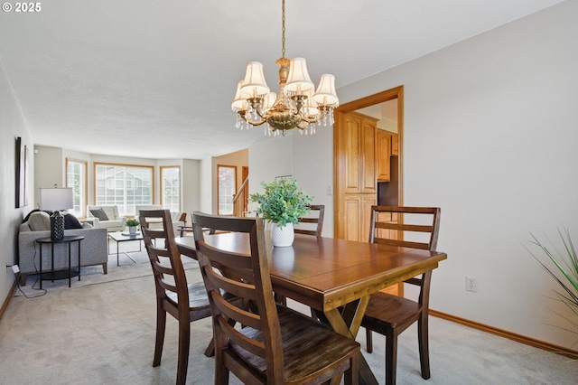 8355 SW 159th Pl, Beaverton, OR 97007 - dining room featuring light colored carpet, a chandelier, and baseboards