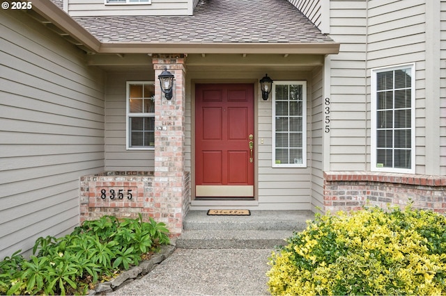 8355 SW 159th Pl, Beaverton, OR 97007 - property entrance featuring a shingled roof and brick siding