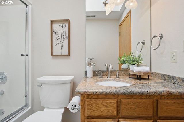 8355 SW 159th Pl, Beaverton, OR 97007 - bathroom featuring toilet, vanity, and combined bath / shower with glass door