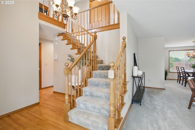8355 SW 159th Pl, Beaverton, OR 97007 - stairs with a chandelier, baseboards, and wood finished floors
