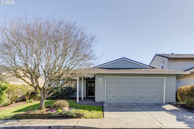 ranch-style home with an attached garage and driveway