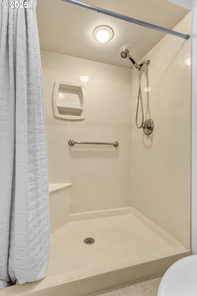 bathroom with a shower stall