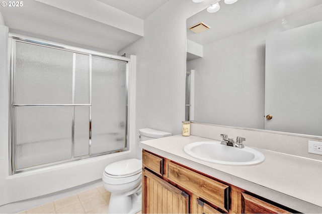 bathroom featuring tile patterned flooring, toilet, bath / shower combo with glass door, visible vents, and vanity