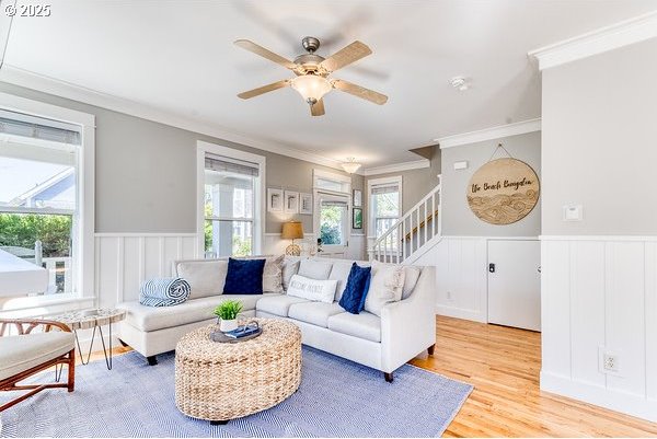 2752 SW Beach Ave, Lincoln City, OR 97367 - living area with ornamental molding, light wood-type flooring, ceiling fan, and stairs