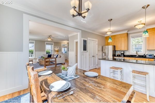 2752 SW Beach Ave, Lincoln City, OR 97367 - dining space with wainscoting, a wealth of natural light, and light wood-style floors