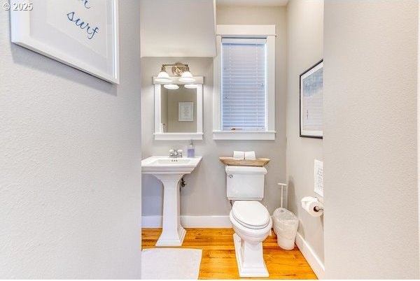2752 SW Beach Ave, Lincoln City, OR 97367 - half bath with baseboards, toilet, and wood finished floors