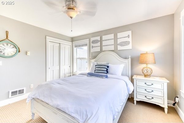 2752 SW Beach Ave, Lincoln City, OR 97367 - carpeted bedroom featuring baseboards, ceiling fan, a closet, and visible vents