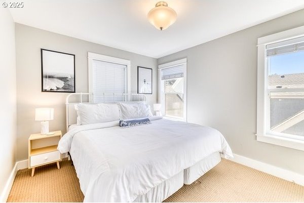 2752 SW Beach Ave, Lincoln City, OR 97367 - bedroom with baseboards, multiple windows, and carpet