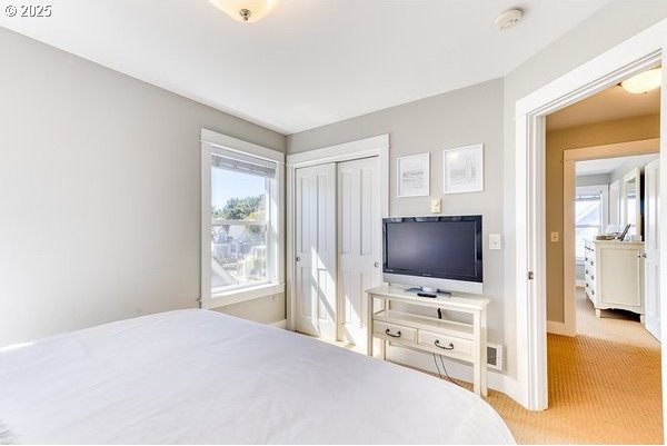 2752 SW Beach Ave, Lincoln City, OR 97367 - bedroom featuring baseboards, a closet, visible vents, and carpet floors