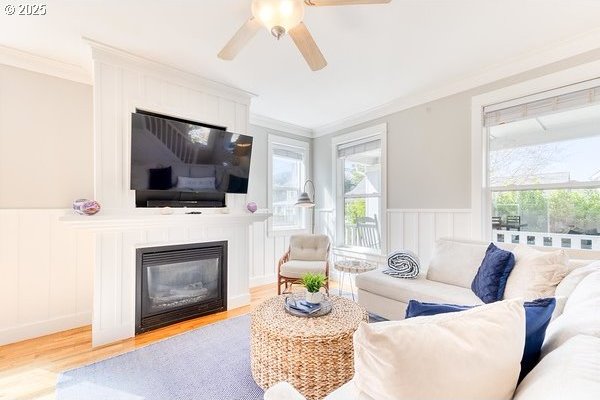 2752 SW Beach Ave, Lincoln City, OR 97367 - living area with ornamental molding, a decorative wall, a large fireplace, and wood finished floors
