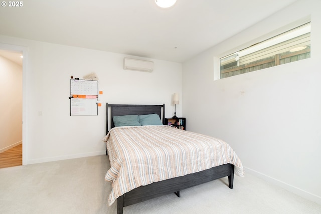 carpeted bedroom with an AC wall unit and baseboards