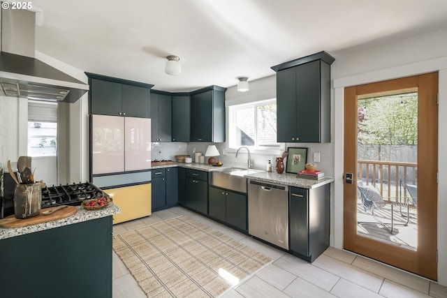 5835 NE 23rd Ave, Portland, OR 97211 - kitchen with dishwasher, wall chimney exhaust hood, backsplash, freestanding refrigerator, and light stone counters