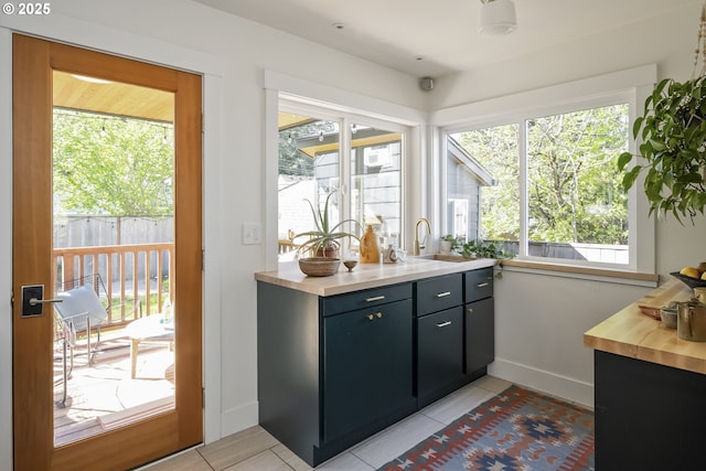 5835 NE 23rd Ave, Portland, OR 97211 - interior space with healthy amount of natural light, light tile patterned floors, and butcher block counters