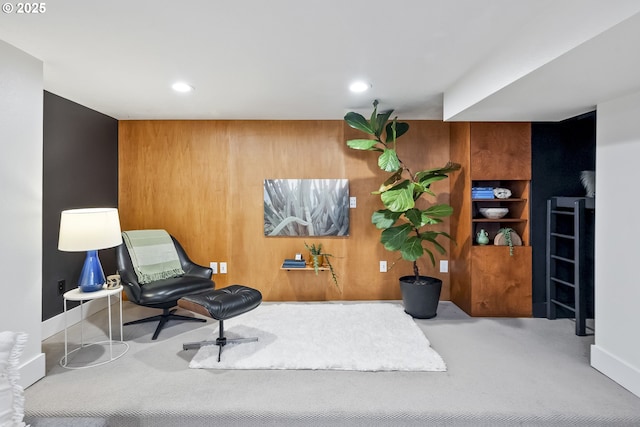 5835 NE 23rd Ave, Portland, OR 97211 - living area with carpet flooring, wood walls, and recessed lighting