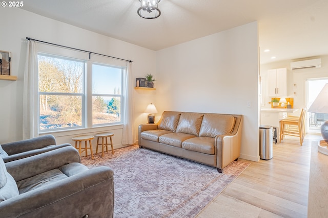 living room with light hardwood / wood-style floors and a wall mounted AC