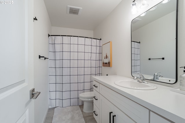 bathroom featuring vanity, toilet, and curtained shower