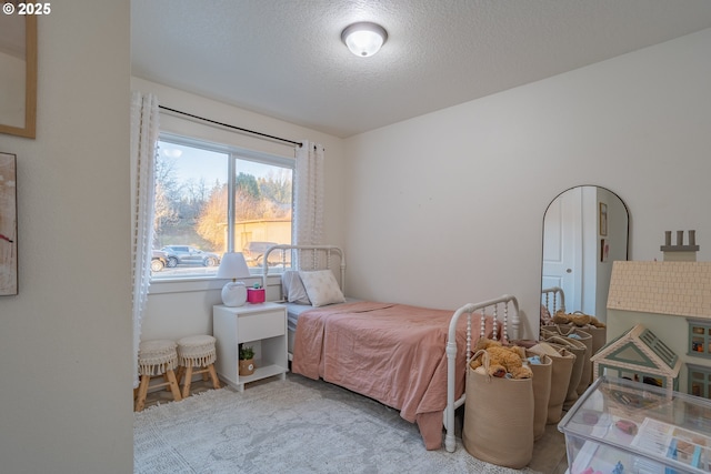 carpeted bedroom featuring a textured ceiling