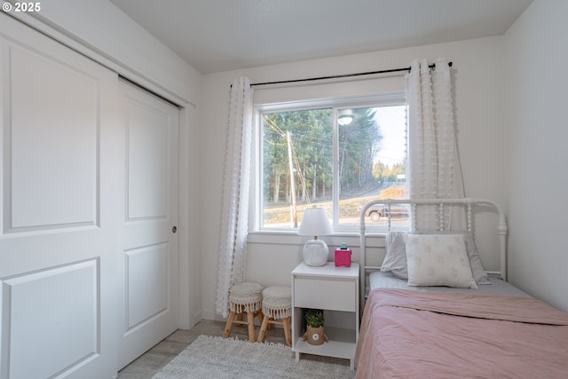 bedroom featuring a closet and light wood-type flooring