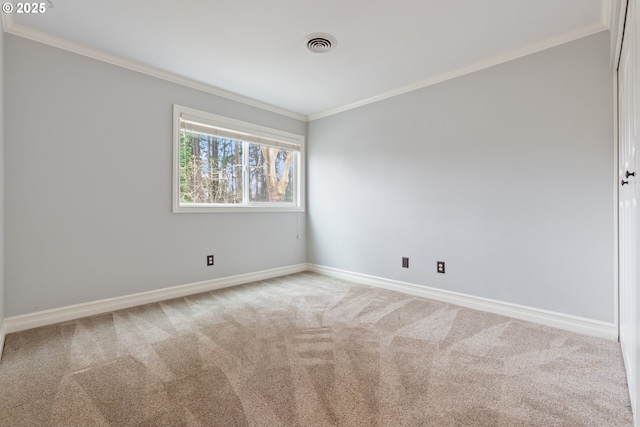 carpeted spare room with visible vents, crown molding, and baseboards