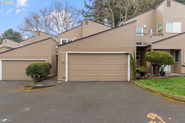 view of home's exterior featuring a garage and driveway