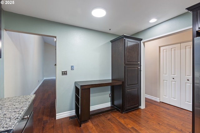 hall featuring recessed lighting, baseboards, and dark wood-style flooring