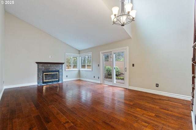 unfurnished living room featuring baseboards, a chandelier, hardwood / wood-style floors, a fireplace, and high vaulted ceiling