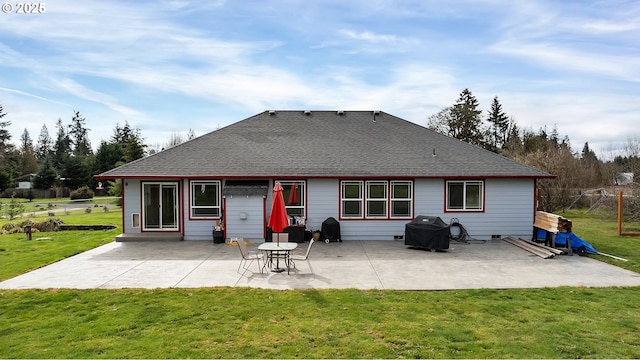 back of house with a yard, a patio, and a shingled roof