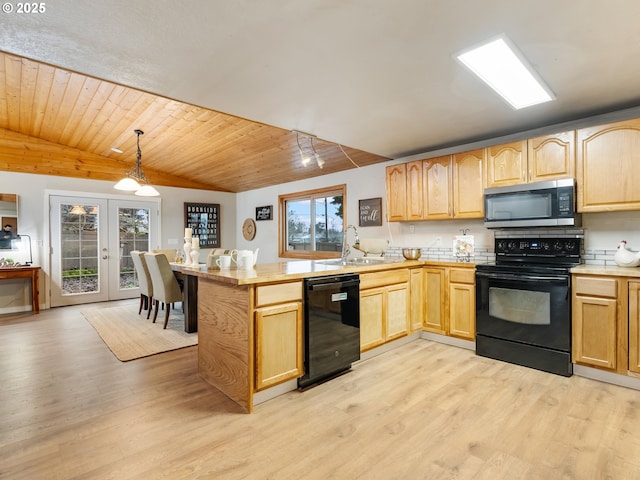 kitchen with french doors, black appliances, sink, hanging light fixtures, and kitchen peninsula