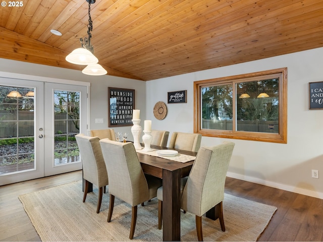 dining area with lofted ceiling, light hardwood / wood-style floors, wooden ceiling, and french doors