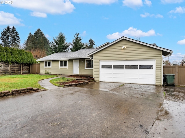 single story home with a garage and a front lawn