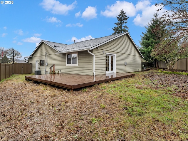 rear view of property featuring central air condition unit and a wooden deck