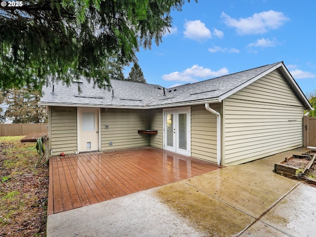 rear view of property featuring french doors and a wooden deck