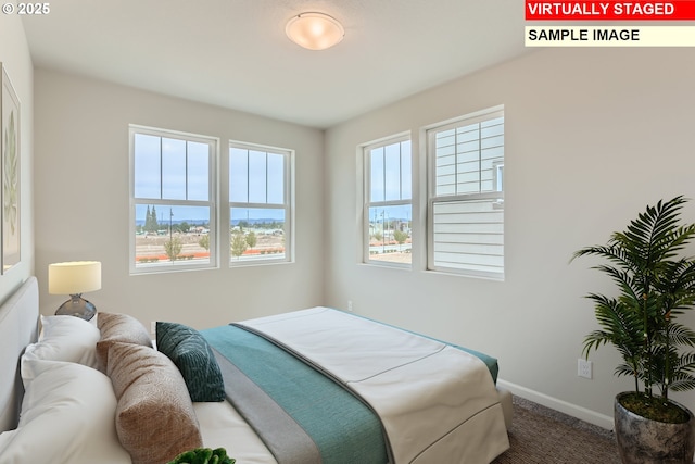 carpeted bedroom featuring baseboards