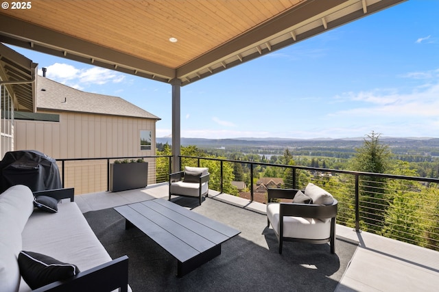 exterior space featuring an outdoor hangout area, a mountain view, and grilling area