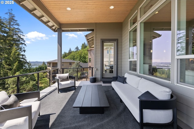 view of patio with an outdoor living space and a balcony