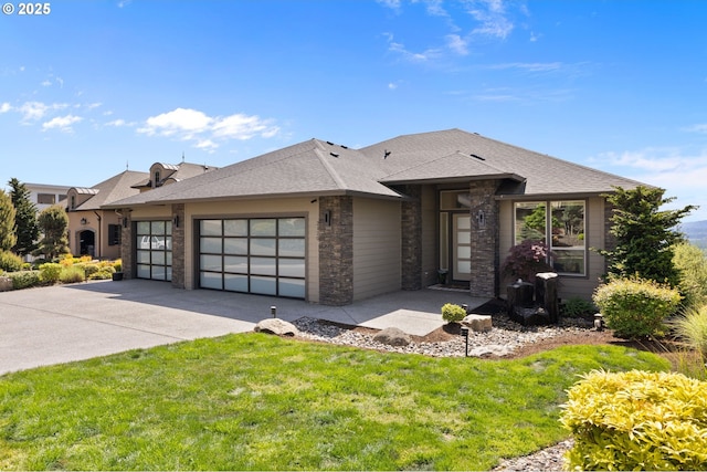 prairie-style home with concrete driveway, a front lawn, stone siding, and a garage