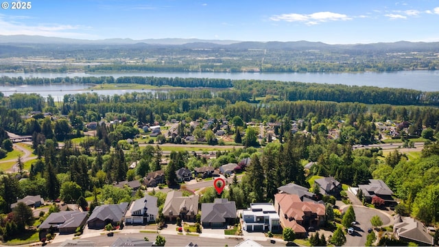 aerial view with a water and mountain view and a residential view