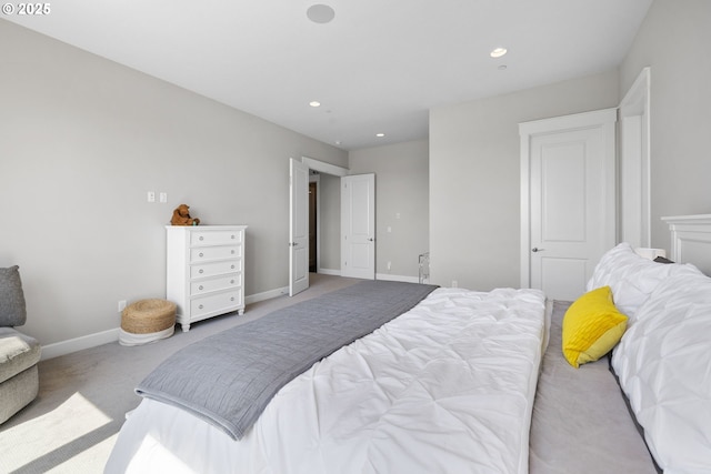 carpeted bedroom featuring baseboards and recessed lighting