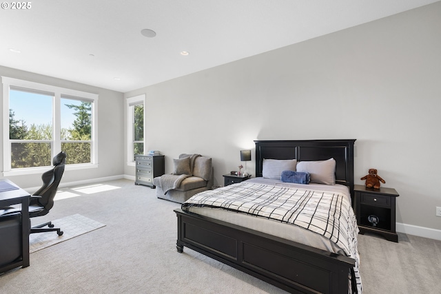 bedroom featuring baseboards, light carpet, and recessed lighting