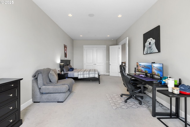 bedroom with recessed lighting, baseboards, light carpet, and a closet