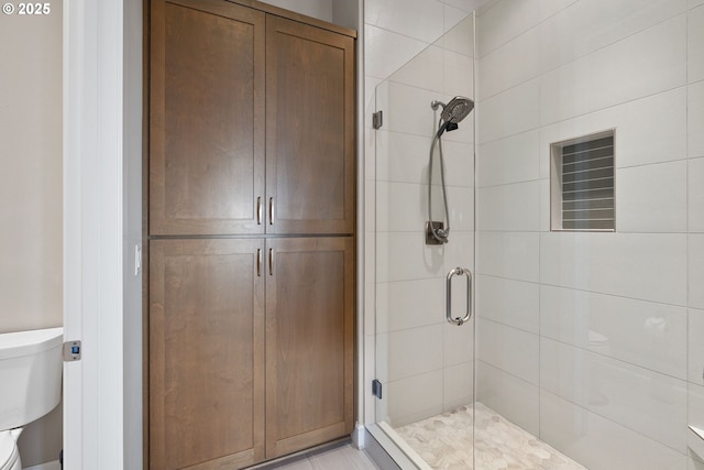 full bath featuring toilet and a shower stall