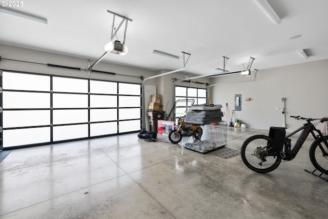 garage with a garage door opener and electric panel