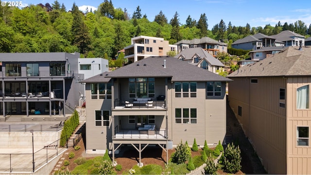 back of house with crawl space, a residential view, and a balcony